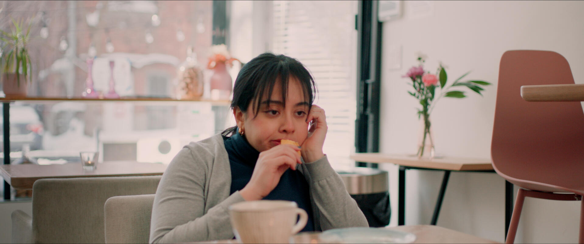 Woman eating a cookie in a short film